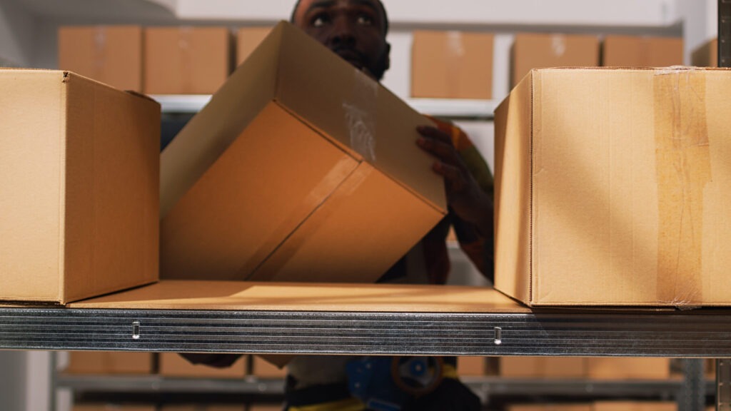 African american man sorting boxes